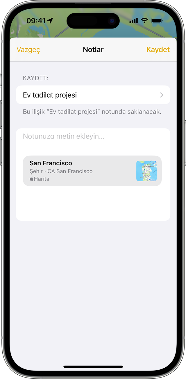 Notlar uygulamasında nasıl ilişik ekleneceğini gösteren iPhone.