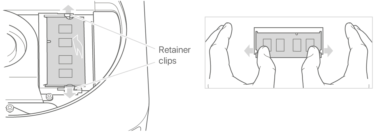 Two hands spreading the retainer clips to loosen a memory module